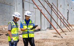 Dr. Chau and Robbie Tiedeman on construction site.