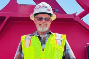 Tony Mounce in front of crane wearing PPE.